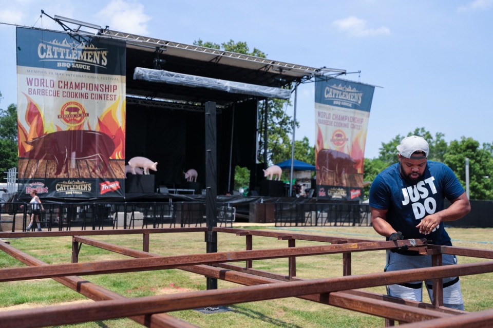 <strong>MJ Davis sets up a wrestling ring near the main stage of the 2022 World Championship Barbecue Cooking Contest at Liberty Park on Wednesday, May 11.</strong> (Patrick Lantrip/Daily Memphian)