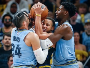 <strong>Memphis Grizzlies defenders Dillon Brooks (left) and Jaren Jackson Jr., (right) apply pressure to Golden State Warriors guard Stephen Curry (middle) on Wednesday, May 11, 2022.</strong> (Mark Weber/The Daily Memphian)