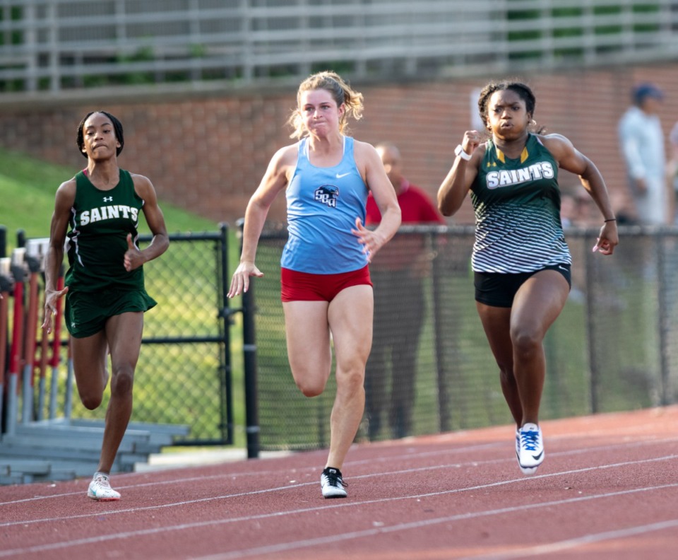 <strong>Dalis Hawkins (right) pours it on during the final stretch of the women's 100m dash to win with a time of 12.46. Coming in a close second is St. Benedict's Ava Esteb (center) with a time of 12.51.</strong> (Greg Campbell/Special to The Daily Memphian)
