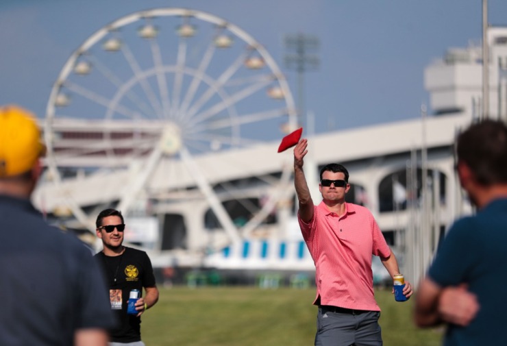 <strong>Josh Baney (right) and Bryan Heenan play a game of cornhole on the lawn of Tiger Lane during the second day of the Memphis in May World Championship Barbecue Cooking Contest on May 12, 2022.</strong> (Patrick Lantrip/Daily Memphian)