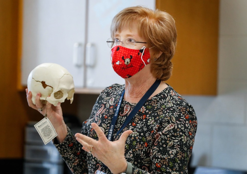 <strong>Arlington High School anatomy teacher Janey Pennington (in a file photo) holds a human skull while discussing a new forensics class during a tour of the school&rsquo;s STEM Hub programs on Jan. 14, 2021.</strong> (Mark Weber/The Daily Memphian)
