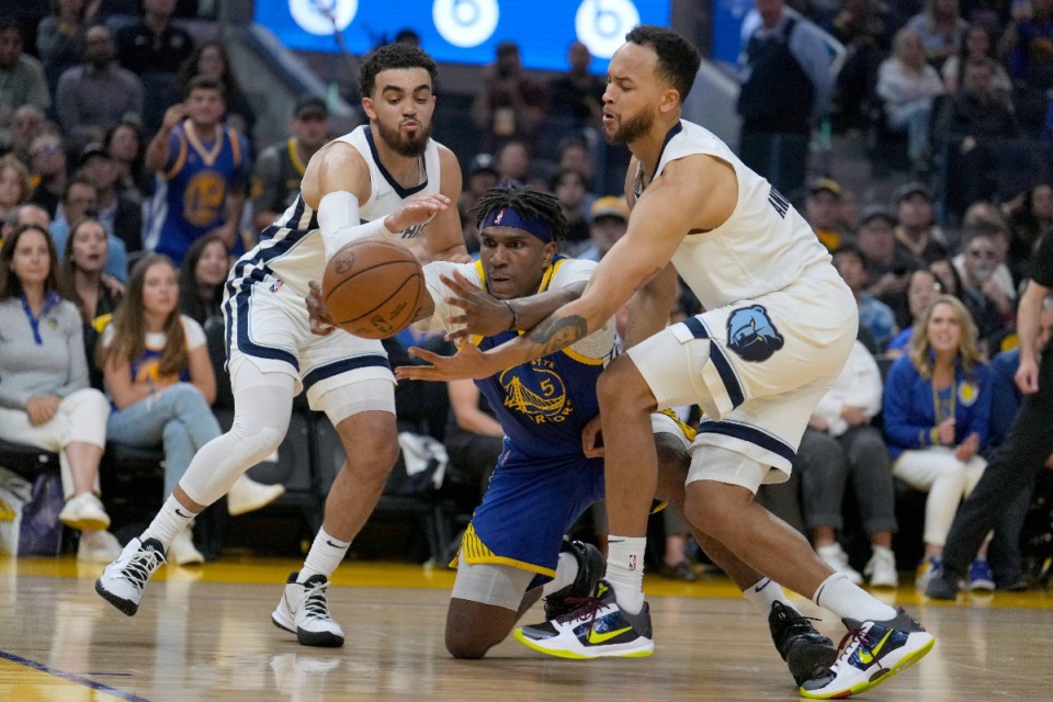 <strong>Golden State Warriors center Kevon Looney (5) coughs up the ball under pressure from&nbsp;the Memphis Grizzlies' Tyus Jones, left, and Kyle Anderson in San Francisco, Friday, May 13, 2022.</strong> (Tony Avelar/AP)