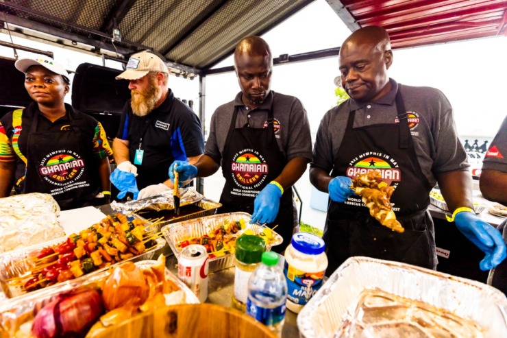 <strong>Left to right: Ghana Grillers Eyram Doris Lumor, Jimmy Shockwell, George Barriga and Livingston Asikoye prep barbecue at the 2022 Memphis in May World Championship Barbecue Cooking Contest at Liberty Park, Friday 13, 2022.</strong> (Ziggy Mack/Special to The Daily Memphian)
