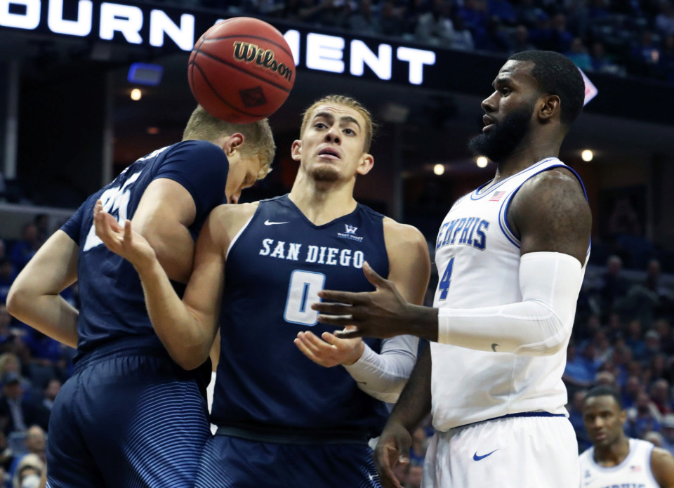 <strong>The Tigers' Raynere Thornton (4) and San Diego Toreros' Isaiah Pineiro (0) vie for the ball during the second half of Tuesday's NIT game at FedExForum.</strong> (Karen Pulfer Focht/Special to the Daily Memphian)