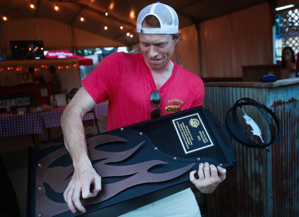 <strong>Jay Martin of the Sweet Cheeks team plays air guitar with the third place trophy in the shoulder category.</strong> (Patrick Lantrip/Daily Memphian)