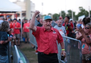 <strong>A member of the Will-B-Cue Team runs up to the stage to accept the third-place trophy in the whole hog category during the last day of the Memphis in May 2022 World Championship Barbecue Cooking Contest.</strong> (Patrick Lantrip/Daily Memphian)