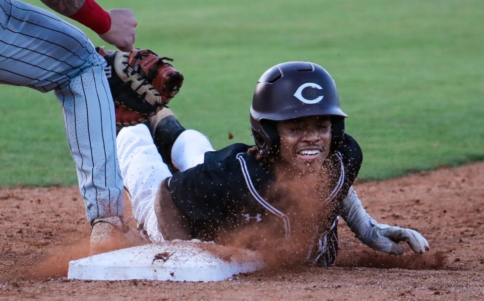 <strong>Collierville High center fielder Austin Smith (41) slides back into first during the May 18, 2022, game against Houston High.</strong> (Patrick Lantrip/Daily Memphian)