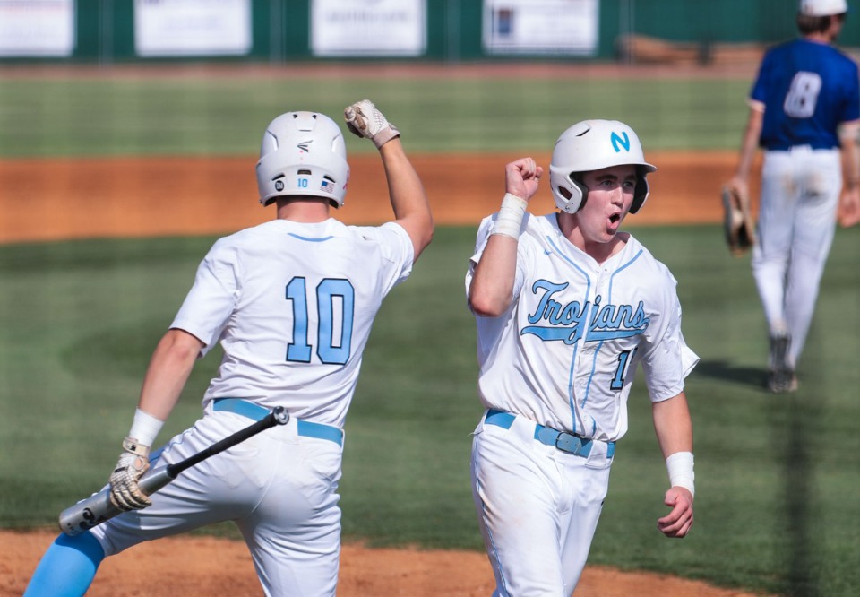 <strong>Northpoint third baseman Jay Ferguson (18) celebrates with teammate Cade Freeze (10) after scoring a run during a May 19, 2022 game against Clarksville Academy.</strong> (Patrick Lantrip/Daily Memphian)