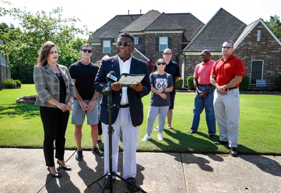 <strong>Shelby County Assessor Melvin Burgess is surrounded by Shelby County Commissioner Amber Mills (left) and her neighbors on Friday, May 20, as he proclaims that the Windsor Place subdivision where they live is in Shelby County.</strong> (Mark Weber/The Daily Memphian)