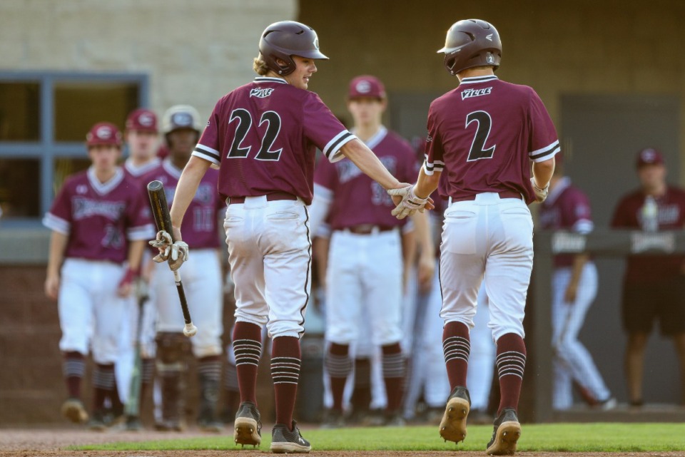 <strong>Collierville&rsquo;s Braden Sheals (22) and Joey Caruso (2) celebrate after a score during the game against the Henry County Patriots on Friday, May 20, 2022.</strong> (Justin Ford/ Special to The Daily Memphian)