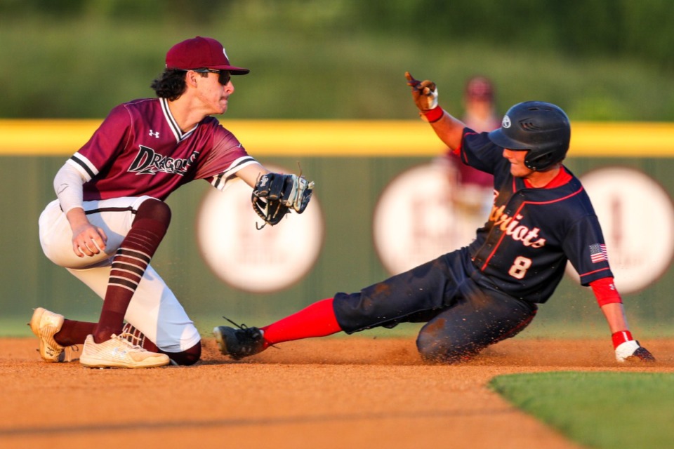 <strong>Collierville second basemen Thomas Crabtree attempts to tag Henry County player JC Olive on Friday, May 20, 2022.</strong> (Justin Ford/ Special to The Daily Memphian)