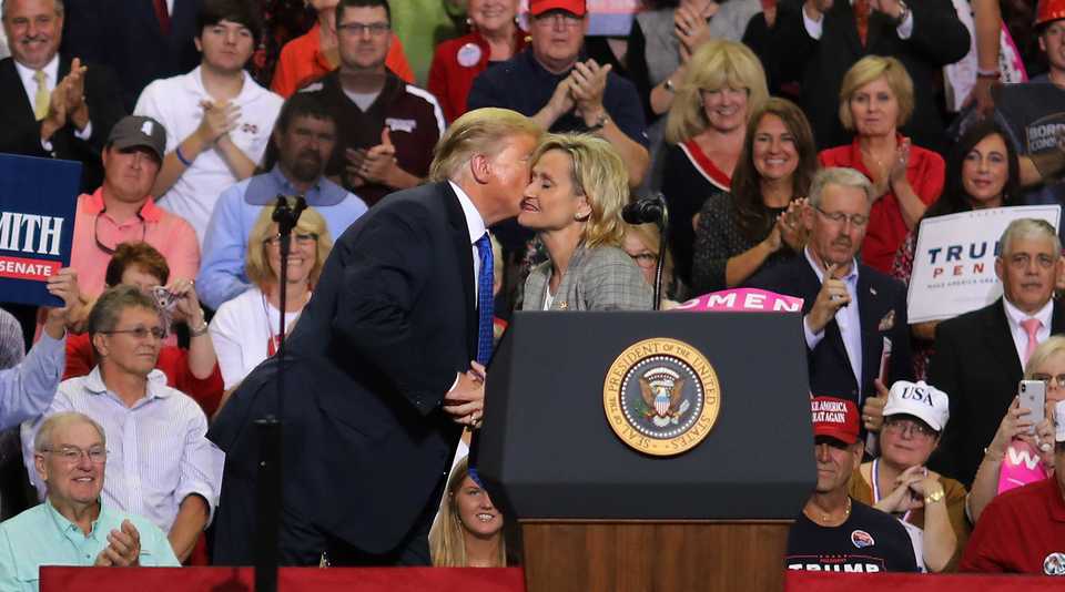 President Trump greets state Sen. Cindy Hyde-Smith at the podium during a campaign rally Tuesday night at the Landers Center in Southaven, Mississippi. (Patrick Lantrip/Daily Memphian)