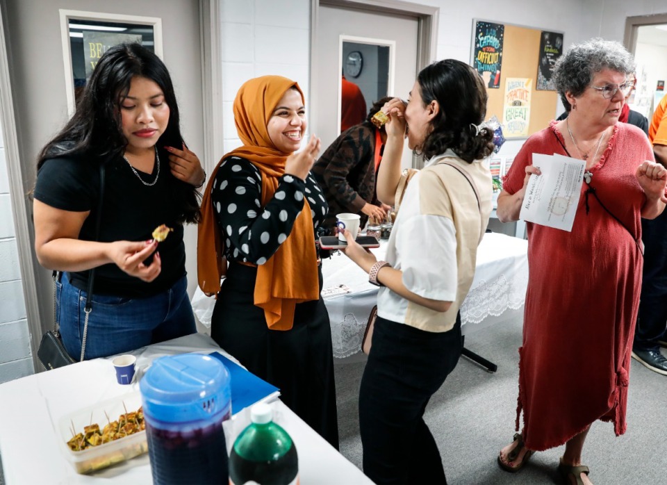 <strong>Students Ahed Al-Hrout (middle left) along with her cousin, Sarah Al-Hrout (middle right) enjoy treats during Shelby Literacy Center&rsquo;s global tea party on Wednesday, May 25, 2022.</strong> (Mark Weber/The Daily Memphian)
