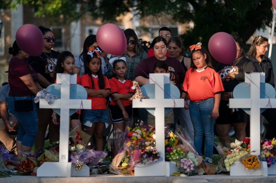 <strong>Children and adults gather at a memorial site to pay their respects for the victims killed in this week's elementary school shooting in Uvalde, Texas, Thursday, May 26, 2022.</strong> (AP Photo/Jae C. Hong)