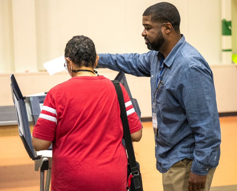 <strong>Bruce Evans instructs Toni M. Wooten about the voting machine at Hope Church, Tuesday, May 3, 2022. Low voter turnout at primaries is creating a debate over the role of the primaries in county and city elections.&nbsp;</strong>(Greg Campbell/Special for The Daily Memphian file)