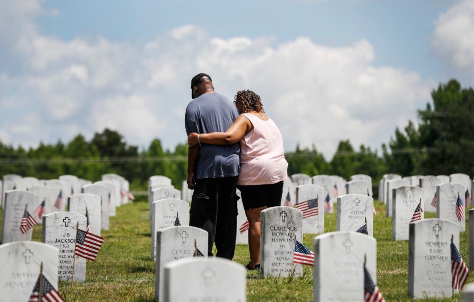 <strong>A couple embraces while visiting the West Tennessee State Veterans Cemetery on Memorial Day, Monday, May 30, 2022.</strong> (Mark Weber/The Daily Memphian)