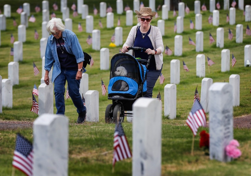 <strong>Felicia Waage (right) walks with her mother Mary Waage (left) while pushing her dog Rae on Memorial Day, Monday, May 30, 2022 at the West Tennessee State Veterans Cemetery.</strong> (Mark Weber/The Daily Memphian)
