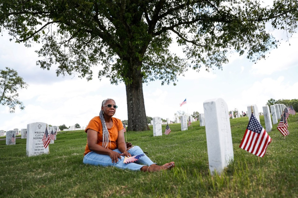 <strong>Yolandis Douglas sits quietly while visiting her parents' gravesites on Memorial Day, Monday, May 30, 2022 at the West Tennessee State Veterans Cemetery</strong>. (Mark Weber/The Daily Memphian)