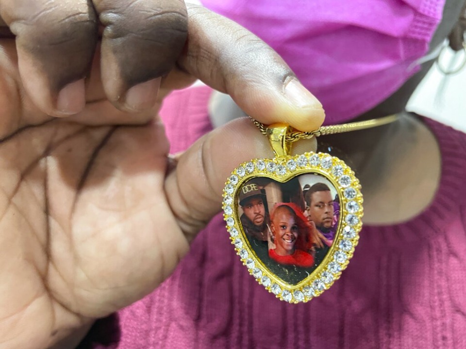 <strong>Angie Brooks shows a locket with a photo of her nephew Artemis Rayford (center of photo) at the Cordell Hull Building on Wednesday, Feb. 23, 2022 after testifying to a House panel in Nashville, about the shooting death of the 12-year-old from Memphis. Before his death, Artemis had written a letter addressing Gov. Bill Lee in opposition to a law that has removed permitting requirements to carry a gun in Tennessee.</strong> (AP Photo/Jonathan Mattise)