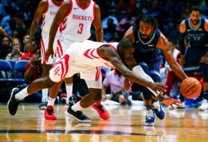<strong>Houston forward James Ennis III (8) tries to steal the ball from Grizzlies guard Mike Conley (11) during the second half of a preseason NBA basketball game, Tuesday, Oct. 2, in Birmingham, Ala. Houston won 131-115.</strong> (Butch Dill/Associated Press)