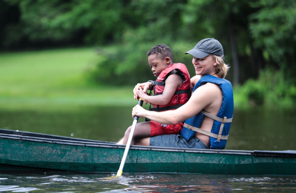 <strong>A counselor at Camp Able helps a camper paddle a canoe.</strong> (Patrick Lantrip/The Daily Memphian)