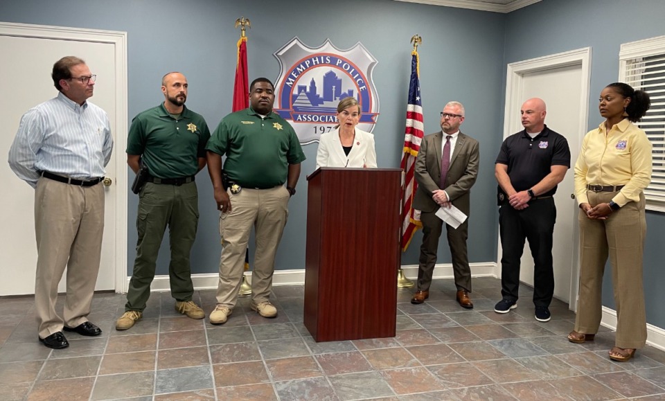 <strong>Dist. Atty. Gen. Amy Weirich (at lectern) speaks at a press conference hosted by the Memphis Police Association, which is endorsing her candidacy in the Aug. 4 election. She is running for reelection against Democratic candidate Steve Mulroy, a law professor and former county commissioner, lawyer and prosecutor. </strong>(Julia Baker/The Daily Memphian)