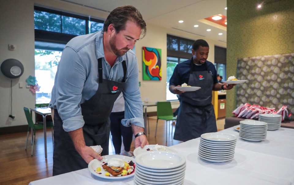 <strong>Drake Leonard and Phillip Dewayne bring out their finished dishes at the Le Bonheur Le Bon Appetit breakfast competition at FedExFamilyHouse June 10, 2022.</strong> (Patrick Lantrip/Daily Memphian)