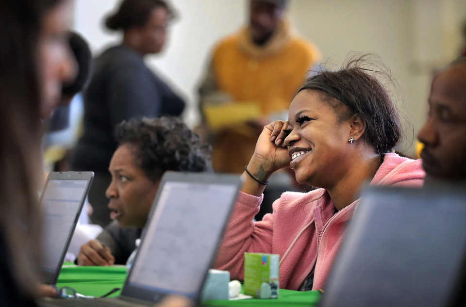 <strong>A relieved Lakiesha Atkins works with a Criminal Court Clerk to get a misdemeanor expunged from her record during a Restoration Saturday event at Mt. Vernon Baptist Church on March 23, 2019, to help motorists with suspended licenses get their license restored. In addition to the license restoration program, members of the community were able to receive veterans services, family counseling, child support help and job information.</strong> (Jim Weber/Daily Memphian)