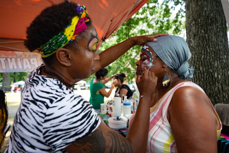 <strong>Nicole Dorsey of Memphis Face Painting works her magic on Jacqueline Jones at Douglass Park on Friday, June 17, 2022.</strong> (Ziggy Mack/Special to The Daily Memphian)