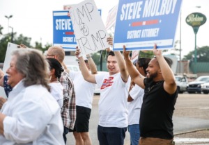 <strong>Supporters of district attorney candidate Steve Mulroy and Shelby County Mayor Lee Harris hold a rally at Poplar and Highland Friday, June 17, the day before former President Donald Trump is set to visit Southaven.</strong> (Mark Weber/The Daily Memphian)