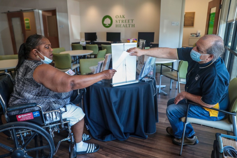 <strong>Memphis Light, Gas and Water Division employee Gaston Moulin (left) gives information to Edith Boone at Oak Street Health in Whitehaven on Tuesday, June 21. A community resource fair had been scheduled for Tuesday, but was postponed due to the summer heat advisory.</strong> (Patrick Lantrip/Daily Memphian)