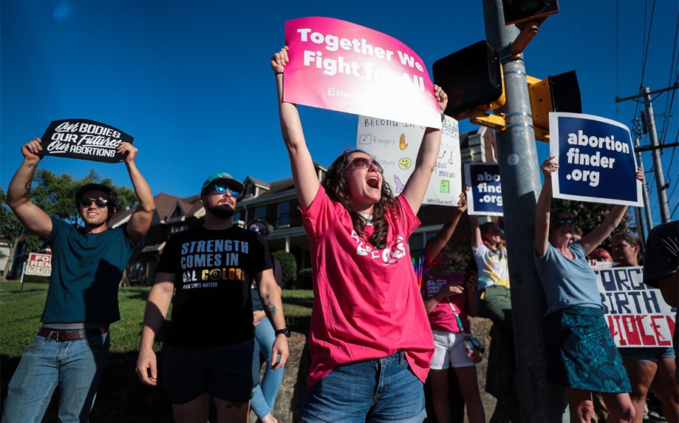 <strong>Alexandra DeMartini protests for abortion rights at the intersection of Poplar Avenue and McLean Boulevard on June 24, 2022.</strong> (Patrick Lantrip/Daily Memphian)