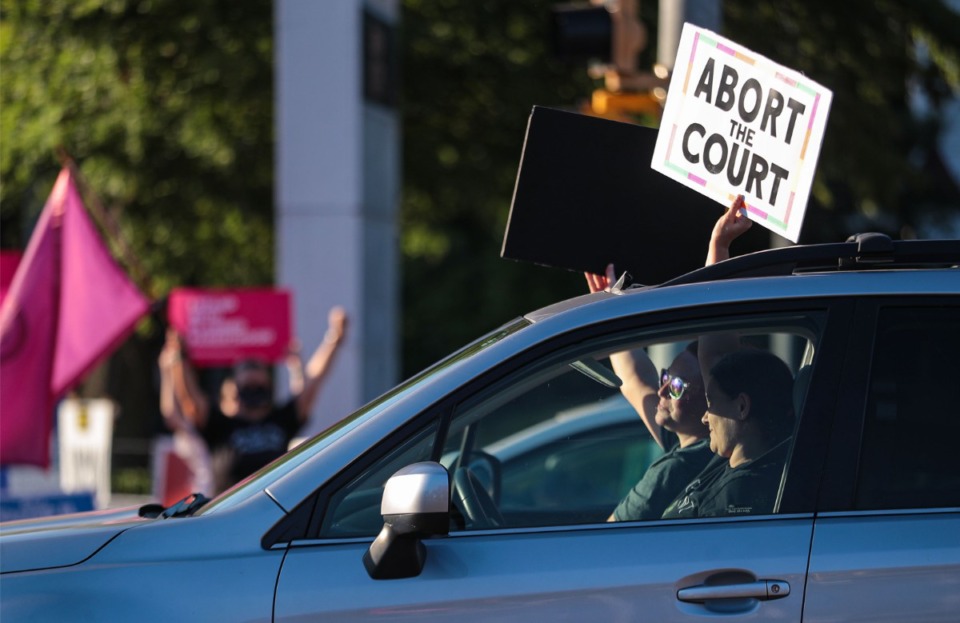 <strong>Many cars showed their support for protesters at the intersection of Poplar Avenue and McLean Boulevard on&nbsp; June 24, 2022.</strong> (Patrick Lantrip/Daily Memphian)