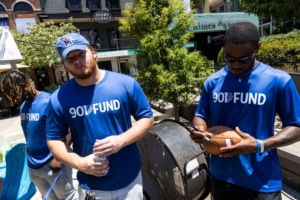<strong>University of Memphis football player Jacob Likes (left) waits while teammate Javon Ivory signs a football during Vitalant Donor Fest, Saturday at Overton Square.</strong> (Brad Vest/Special to The Daily Memphian)