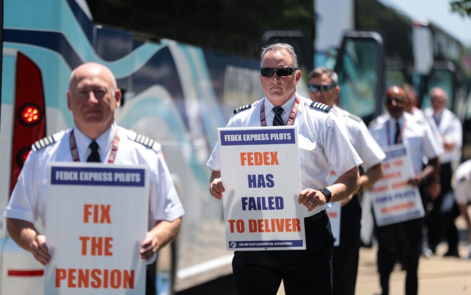 <strong>FedEx pilots embark from a charted bus to picket outside of the Air Operations center June 28, 2022.</strong> (Patrick Lantrip/Daily Memphian)
