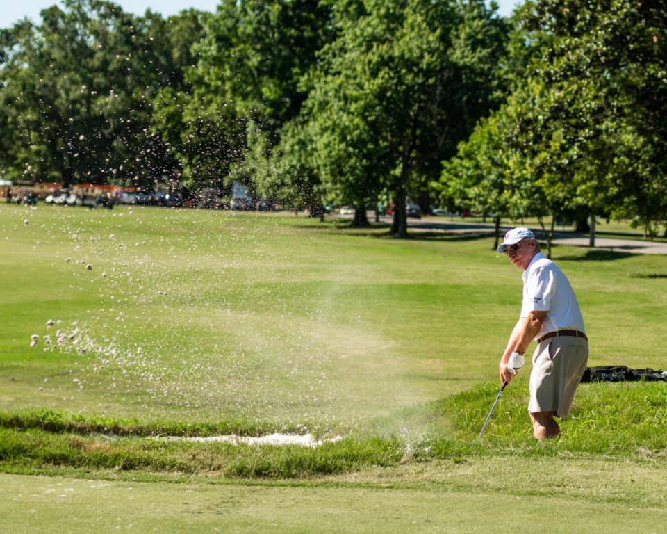 <strong>Tom Whitman chips onto the green out of a sand trap on hole number one at Overton Park Golf Course. The course has been completely redesigned and is now open to the public.</strong> (Houston Cofield/Special To The Daily Memphian)