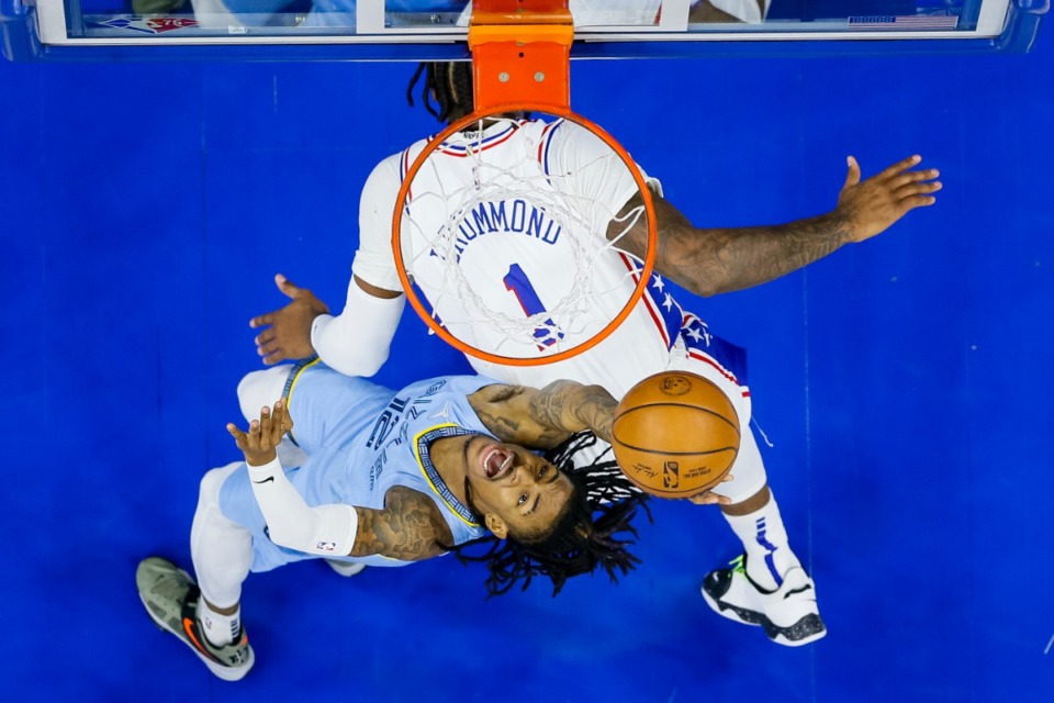 <strong>Memphis Grizzlies' Ja Morant, bottom, shoots against Philadelphia 76ers' Andre Drummond, top, during the first half of an NBA basketball game, Monday, Jan. 31, 2022, in Philadelphia.</strong> (AP Photo/Chris Szagola)
