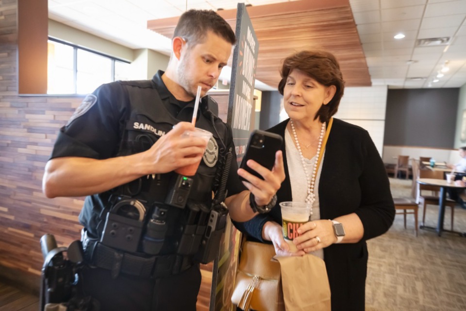 <strong>Policeman Adam Sandlin speaks with Susan Edwards at Bartlett Police Coffee with a Cop meet &amp; greet at Panera Bread in Bartlett on Thursday June 30, 2022.</strong> (Ziggy Mack/Special to The Daily Memphian)