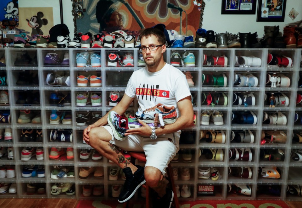 <strong>Adam Jenkins (at home, with his personal shoe collection) is one of more than 40 vendors who lost merchandise during a burglary at M-Town Market in Binghampton. He lost about $30,000 worth of merchandise in the crime that occurred the night before a popup shop.</strong> (Mark Weber/The Daily Memphian)