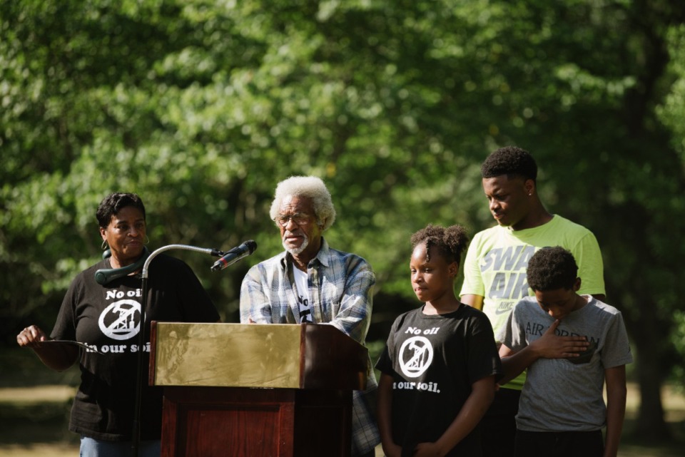 <strong>Family members surround Clyde Robinson as he speaks Saturday at Alonzo Weaver Park in South Memphis, where about 100 people gathered to mark the one-year anniversary of the cancellation of the Byhalia Pipeline. (Lucy Garrett/Special to The Daily</strong> <strong>Memphian)</strong>