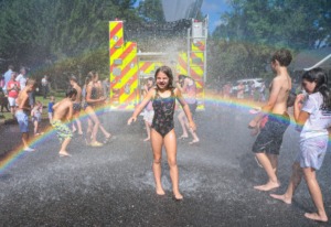 <strong>Memphis firefighters hose down neighborhood kids after the 73rd annual High Point Terrace Fourth of July parade July 4, 2022.</strong> (Patrick Lantrip/Daily Memphian)