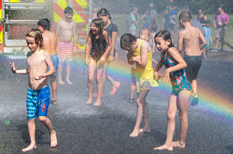 <strong>Neighborhoods kids enjoy the water hose at the 73rd annual High Point Terrace Fourth of July parade July 4, 2022.</strong> (Patrick Lantrip/Daily Memphian)