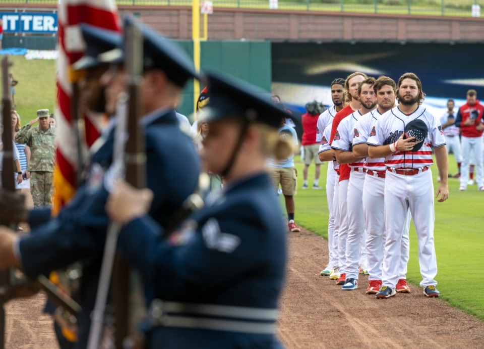 <strong>Memphis Redbirds players pause during the presentation of the honor guards at the beginning of the game for the AutoZone Park Fourth of July celebration, Friday, July 1, 2022.</strong> (Greg Campbell/Special for The Daily Memphian)