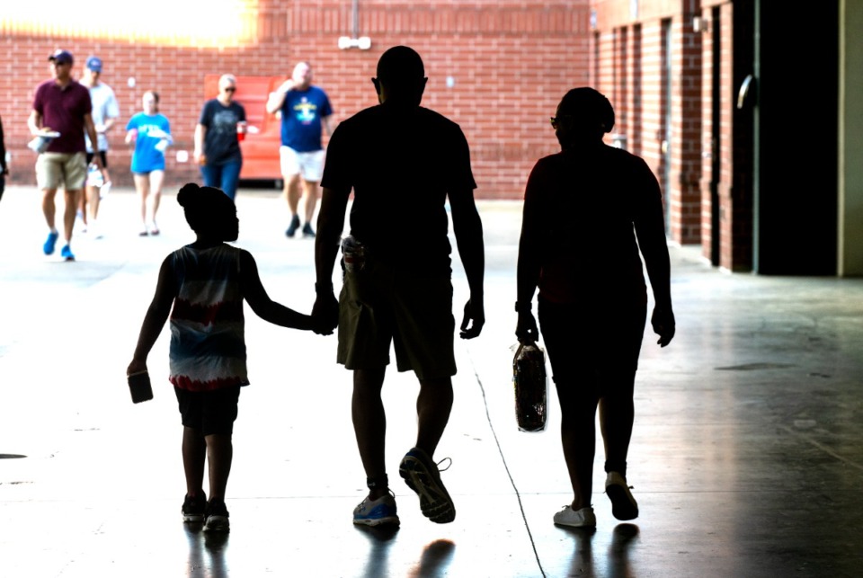 <strong>A family walks to the all-you-can-eat hamburgers and hot dogs at the AutoZone Park Fourth of July Celebration Weekend at the Redbirds game, Friday, July 1, 2022.</strong> (Greg Campbell/Special for The Daily Memphian)