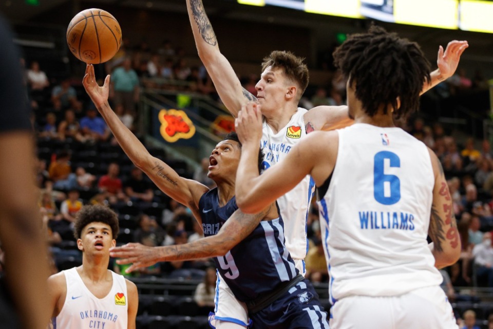 <strong>Memphis Grizzlies guard Ronaldo Segu (9) shoots against Oklahoma City Thunder guard Vit Krejci and forward Jaylin Williams (6) on July 6 in Salt Lake City.</strong> (Jeff Swinger/AP)