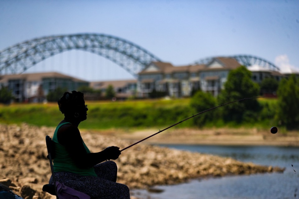 <strong>Jaqueline Davis fishes in the Wolf River Harbor underneath the A.W. Willis Bridge July 7, 2022. Davis has been coming to this spot for over a decade.&nbsp;</strong>(Patrick Lantrip/The Daily Memphian)