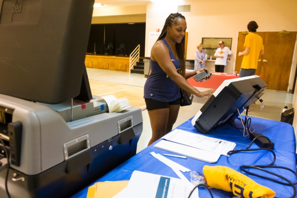 <strong>Dawn Campbell experiments with new Express Vote testing machine Saturday, July 16, 2022 at Riverside Missionary Baptist Church.</strong> (Ziggy Mack/Special to The Daily Memphian)