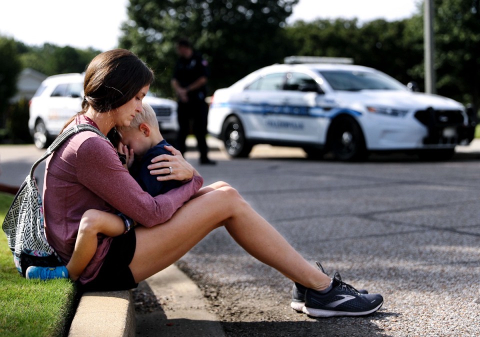 <strong>Carly McWatters holds her son at Collierville Town Hall Sept. 24, 2021 to pay their respects to the victims of the Kroger shooting the day before.</strong> (Patrick Lantrip/Daily Memphian file)