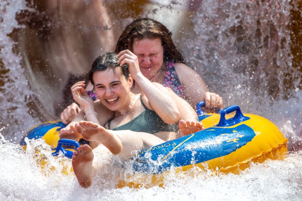<strong>Olivia Kleemann, front, and Keera Gilliland, both 20, of Butler, shoot out of a water slide at Sandcastle Water Park on its opening day for the summer, Saturday, May 21, 2022, in Homestead, Pennsylvania.</strong> (Alexandra Wimley/Pittsburgh Post-Gazette via AP)