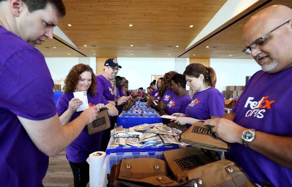 FedEx volunteers make short work of 14,000 care packages for military